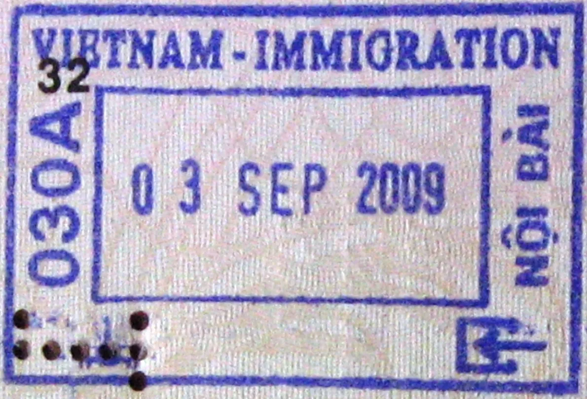 Close-up of a purple Vietnam immigration entry stamp reading VIETNAM - IMMIGRATION with an entry date and the Noi Bai airport name
