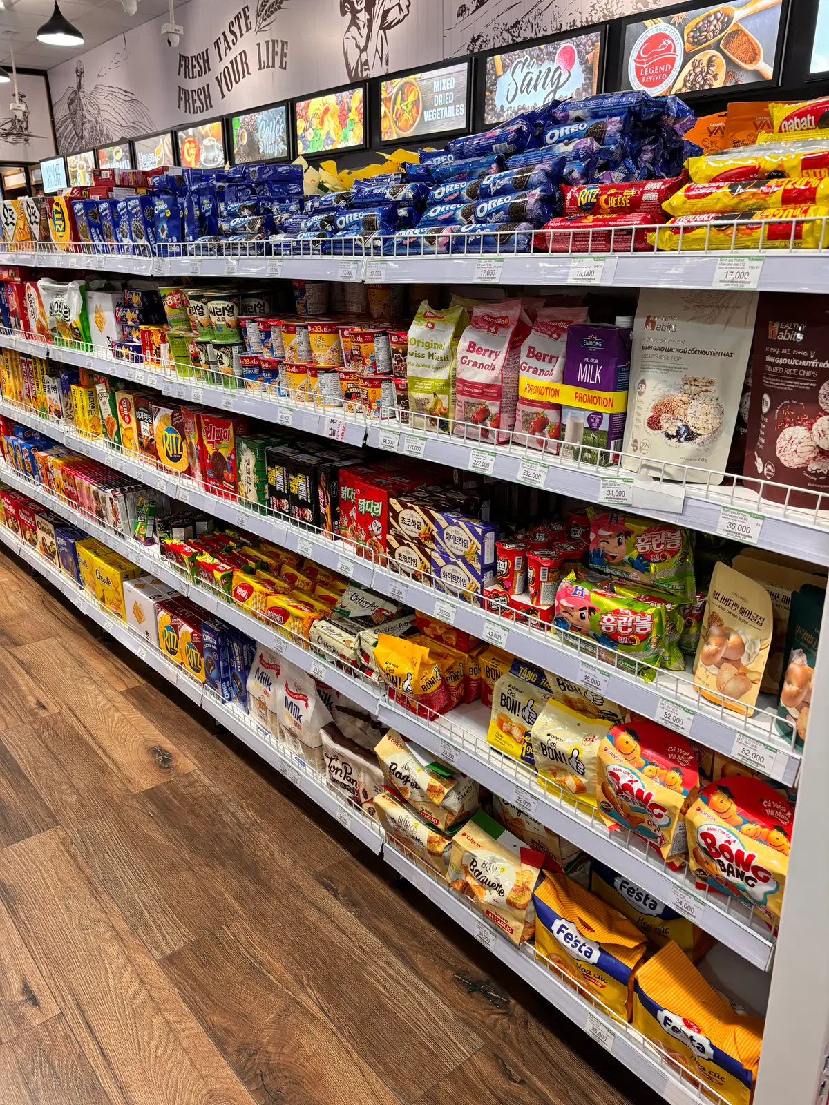 Long shelf of Korean snack packets and instant food in bright wrappers