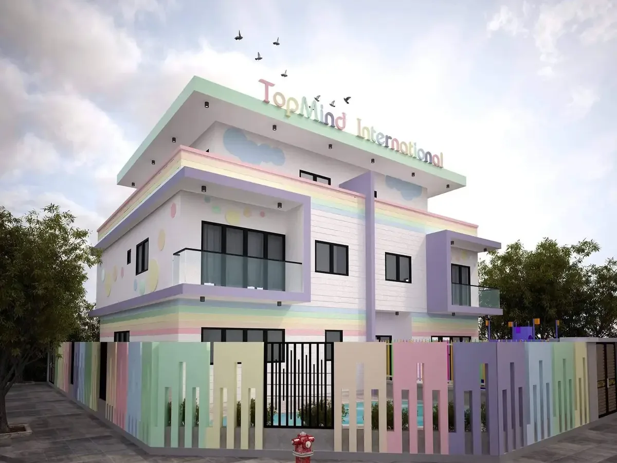 Pastel-coloured preschool building with a multi-coloured fence in front