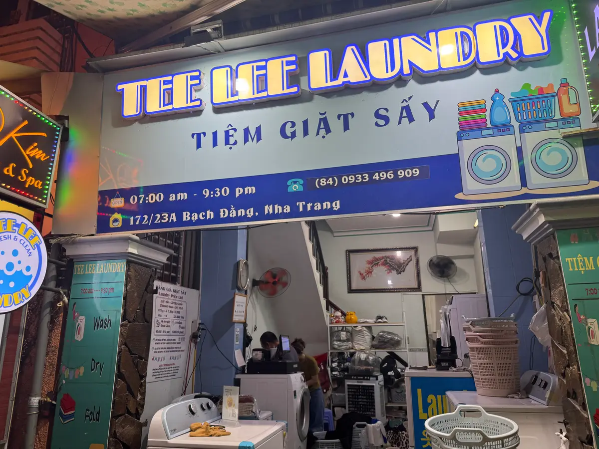 Tee Lee Laundry sign above a small open-front laundry shop