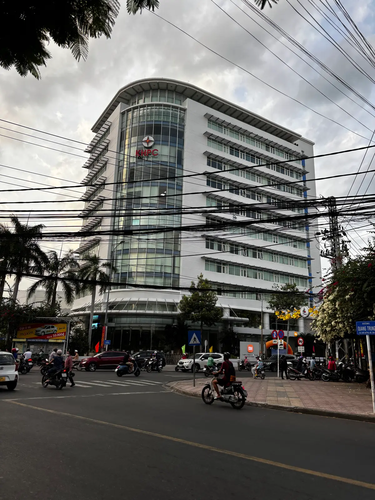 Tall office building of the power company seen from the street with traffic below.