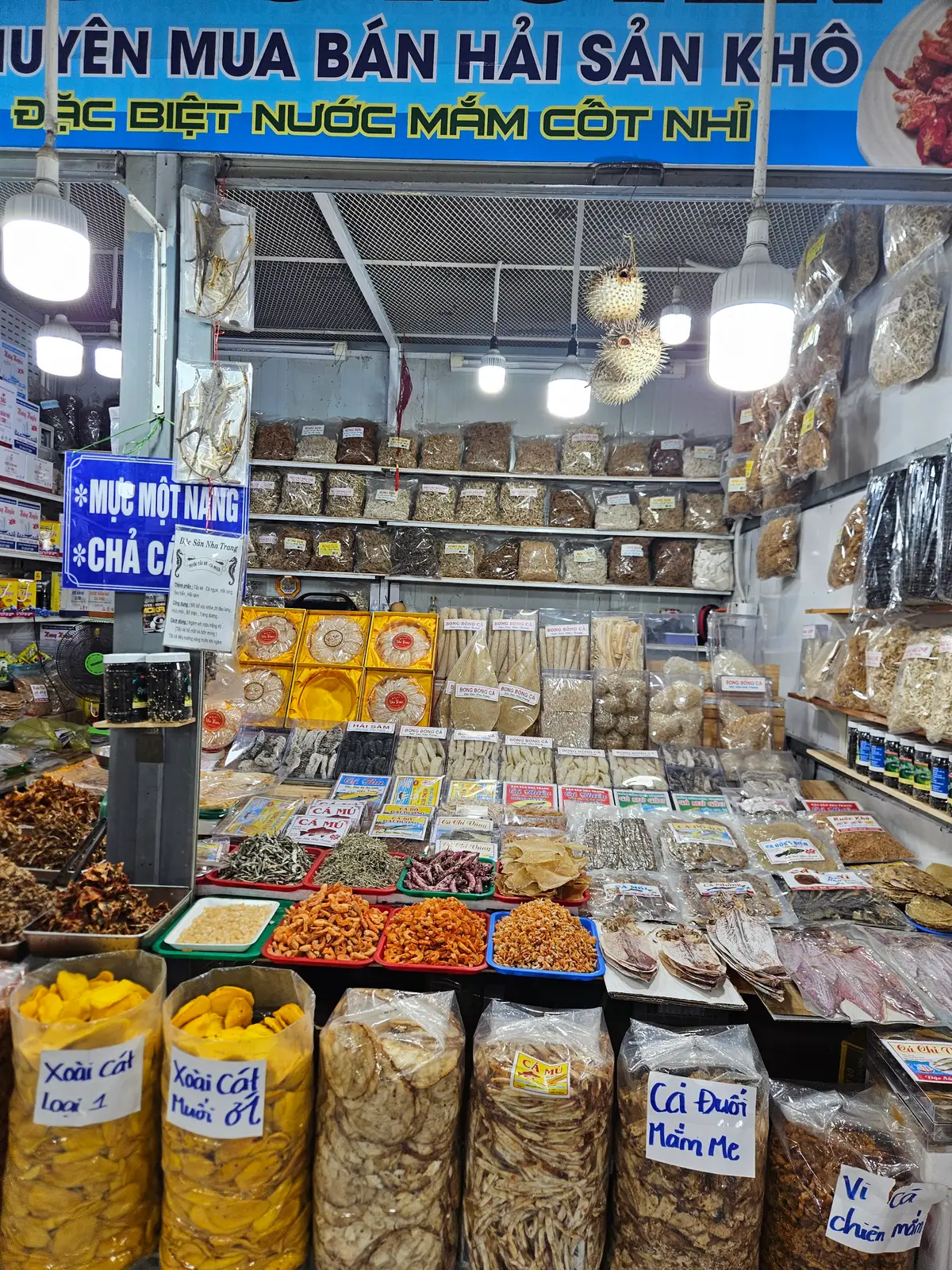 Shop shelves stacked with dried squid, shrimp and packaged seafood snacks