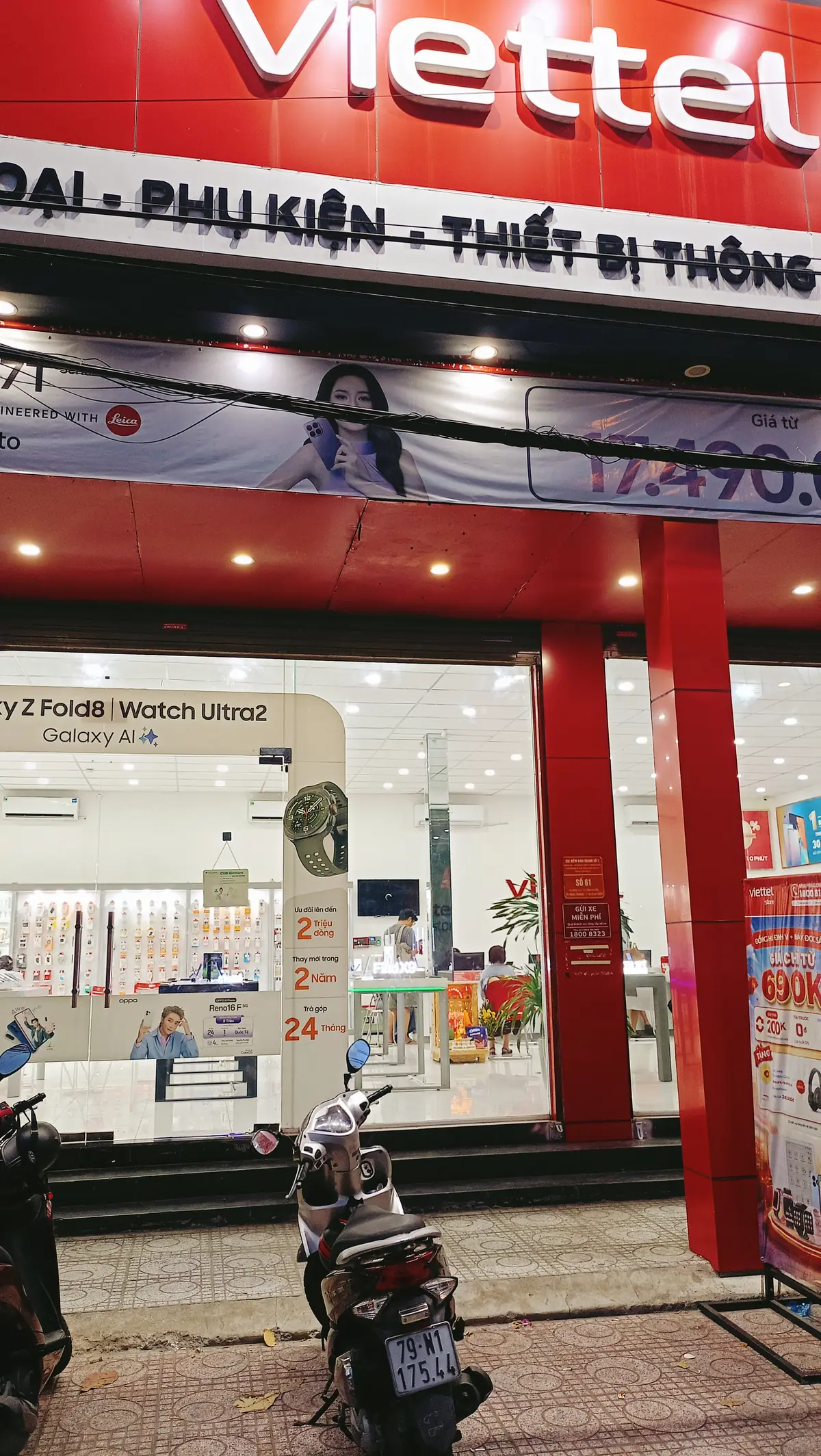 Red store front with a phone display in the window and red pillars