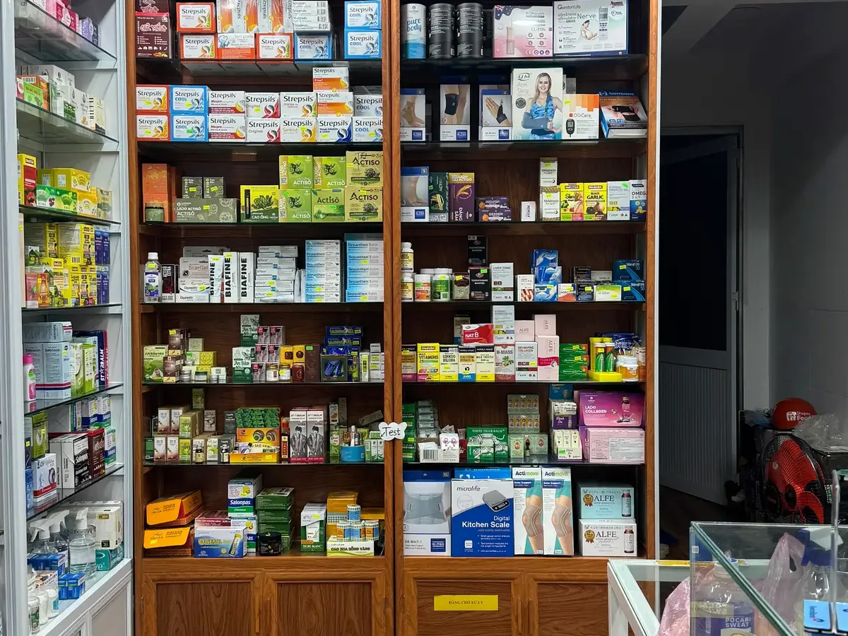 Wooden shelves packed with boxed medicines and health products