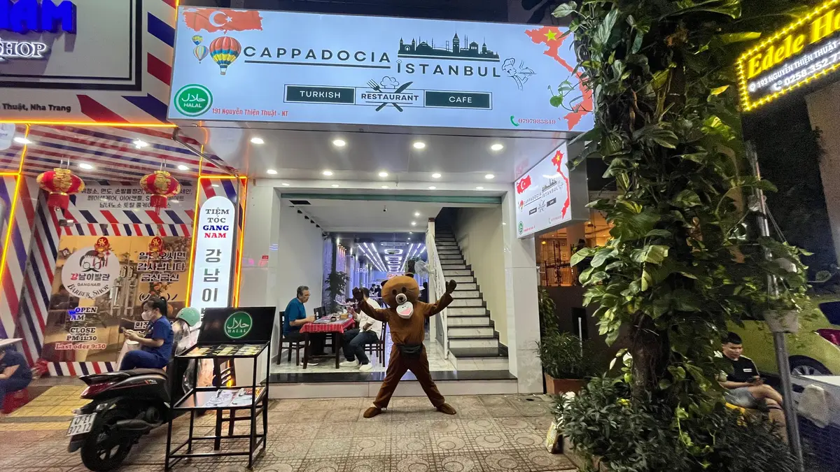 Restaurant entrance with a Cappadocia Istanbul sign, a stair and a costumed mascot