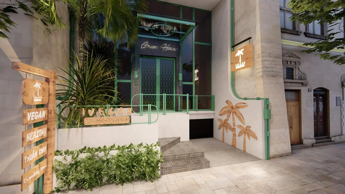 Green-framed cafe entrance with palm tree murals and plants